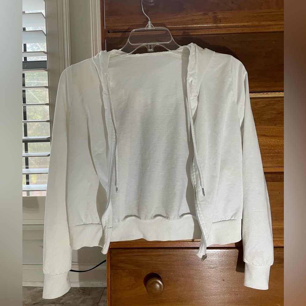 Lightweight white zip up jacket.